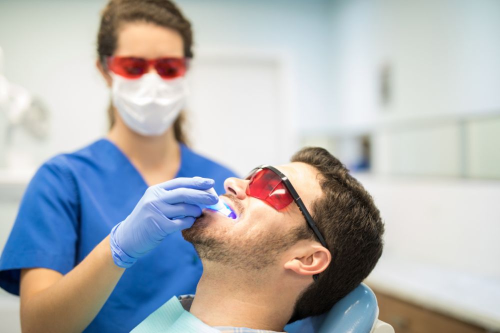 a man is having teeth whitening treatment